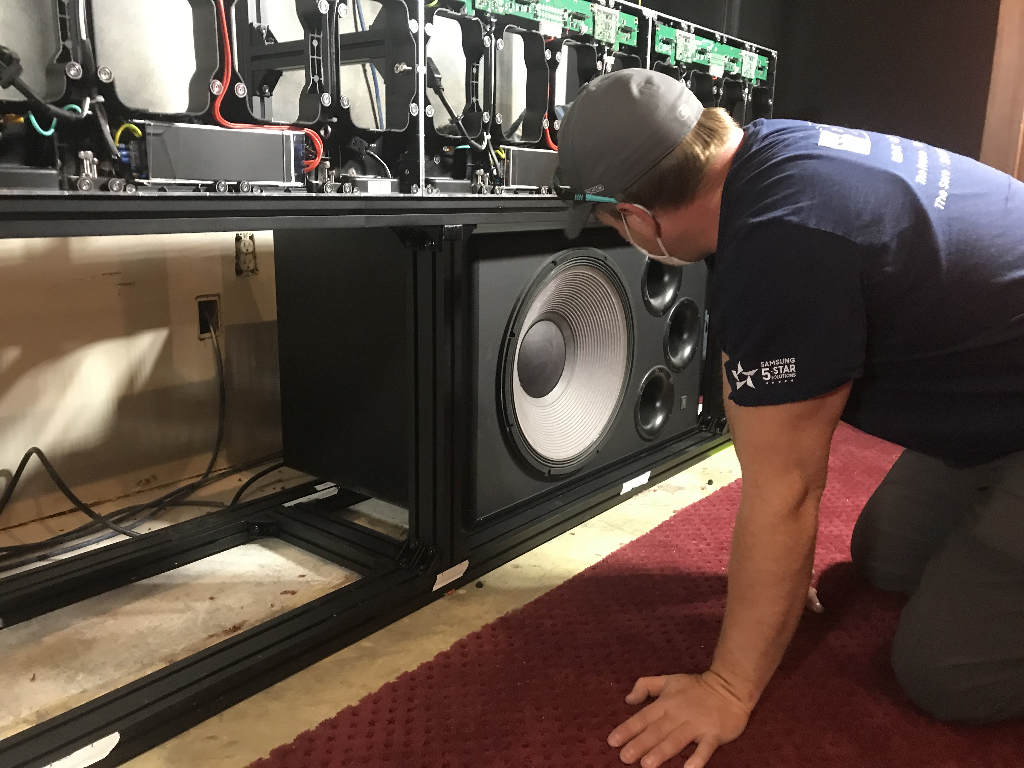 Technician integrating loudspeakers and an LED display system